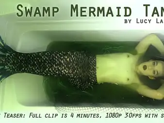 Lucy LaRue plays along to commerce of a Swamp Mermaid Tank in a super-hot solo shot at amusement